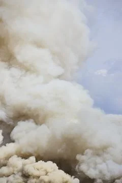Scrap Yard Smoke Cloud Rising Against Blue Sky Eye-Level Perspective Stock-Fotos