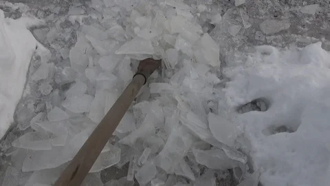 Scraper , ice breaker clearing large chunks of broken ice on walkway Stock Footage 120426141