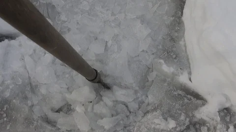 Scraper , ice breaker clearing large chunks of broken ice on walkway Stock Footage 120426148