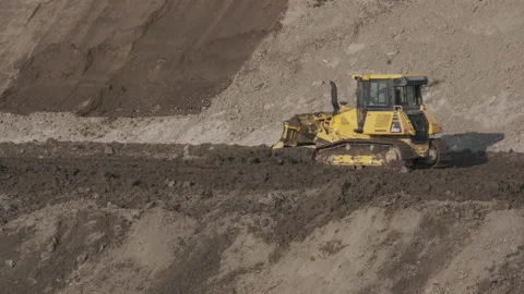 Scraper machine at work to level the river bed Stock Footage 154875056