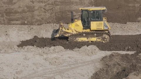 Scraper machine at work to level the river bed 動画素材 154883979