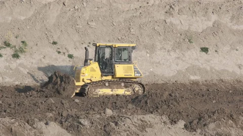 Scraper machine at work to level the river bed Stock Footage 154884875