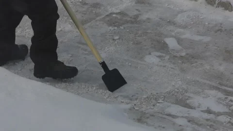 Scraper removing ice from sidewalk off the pavement 動画素材 326339502
