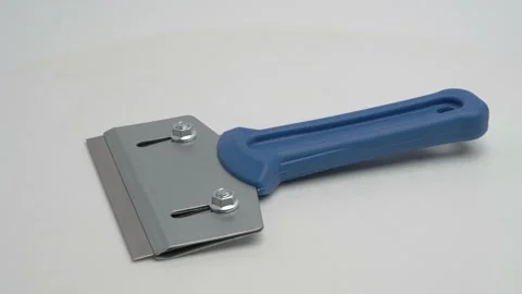 Scraper for removing old paint on a white background. Stockbeeldmateriaal 265865845