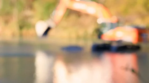 Scraper is waiting in the middle of water river Backhoe Bulldozer Escavator Stock Footage 122197244