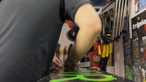 Scraping And Brushing Excess Wax Off Snowboard Stock Footage 125855680