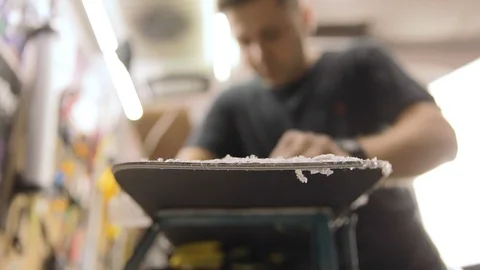 Scraping And Brushing Excess Wax Off Snowboard Video stock 125855708
