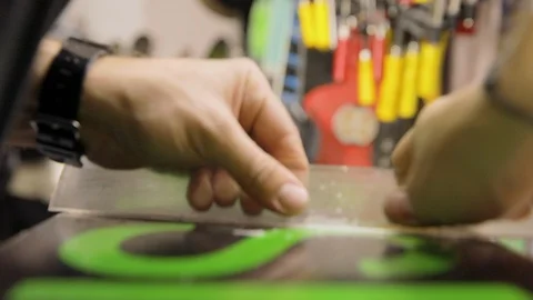 Scraping And Brushing Excess Wax Off Snowboard. Close Up Stock Footage 125855844