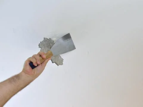 Scraping a Ceiling with a Spatula Stock Photos