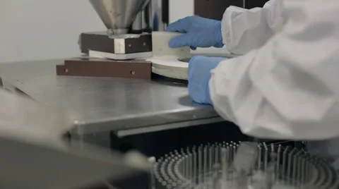 Scraping Excess Powder from Encapsulation Rotary Disc Stock Footage 68643158