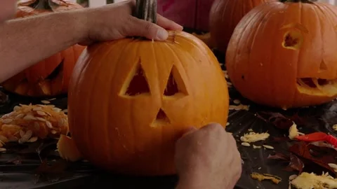 Scraping fresh pumpkin while making a lantern. Preparation of paraphernalia f Stock Footage 272459480