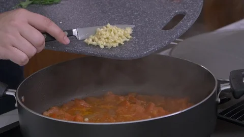 Scraping Garlic into Pan Stock Footage 97759050