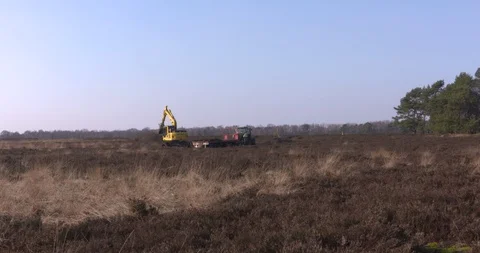 Scraping heather and topsoil using an excavator Stock Footage 86461248
