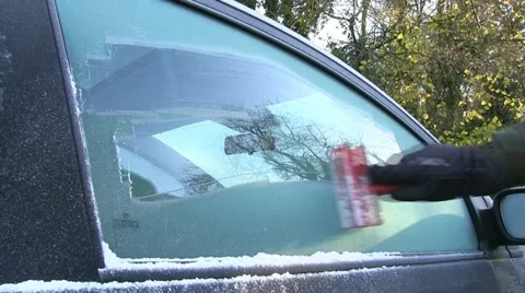 Scraping ice off a car window Stock Footage 12672881