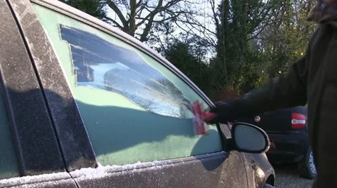 Scraping ice off a car window Stock-Footage 12757675