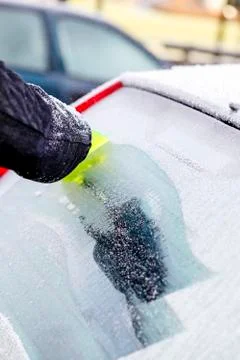 Scraping ice from car window Stock-Fotos