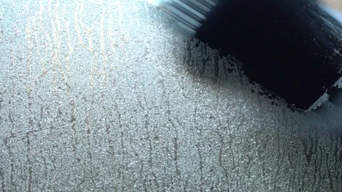 Scraping ice off car windscreen Stock Footage 123408391
