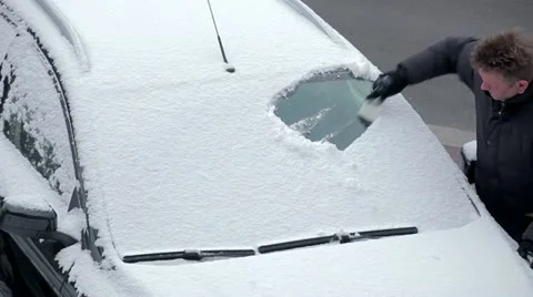 Scraping the ice of a car windshield in 1080p Stock Footage 20281135
