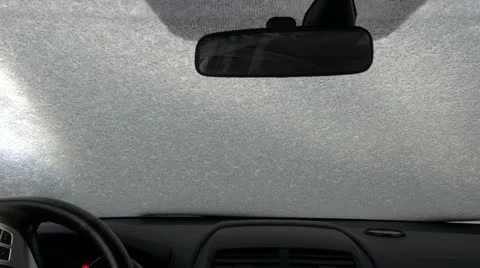 Scraping off the ice on a car's windshield Stock Footage