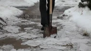 Scraping Ice Off From The Ground Using A Spade After A Major Ice Storm Stock Footage