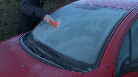 Scraping ice from windshield Stock Footage 60777436