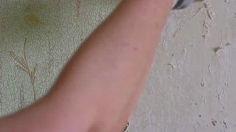 Scraping old wallpaper from the wall with spatulas and improvised means Stock Footage 168796157