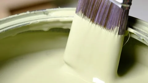 Scraping paint off of paint brush Stock Footage 138956457