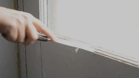 Scraping paint off a window frame Stock Footage 94097428