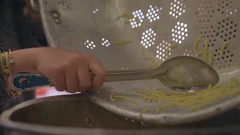Scraping pot clean of noodles Video stock 82232051