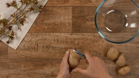 Scraping potatoes for cooking soup Stock Footage 103465046