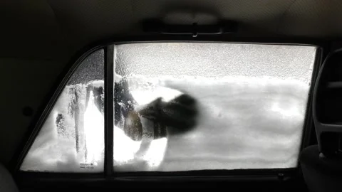 Scraping snow off the windshield. Stock Footage 167625681