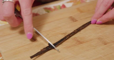 Scraping vanilla bean stem with knife Stock Footage 249367900