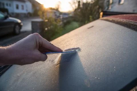 Scraping windscreen during winter Stock Photos
