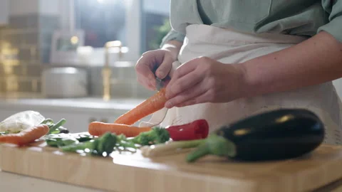Scrapping carrots slowmotion Stock Footage 254585229