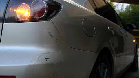 Scratch abrasion on car back bumper due to minor accident with flashing emergenc Stock Footage 213388889