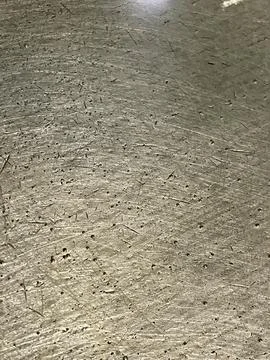Scratched and weathered metallic surface texture with fine grain Stock Photos