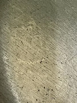 Scratched and weathered metallic surface texture with fine grain and tiny dark Stock Photos