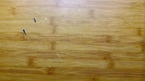 Scratched bamboo surface with deep gouges scuffs and rich natural wood grain  Stock Photos