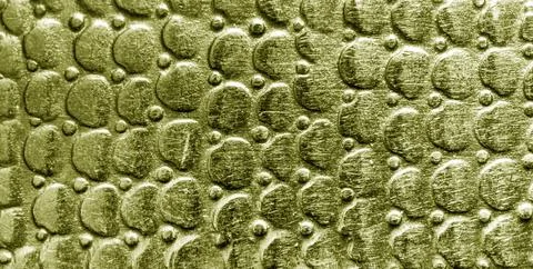 Scratched bronze texture with round pattern. Abstract metallic background. Stock Photos