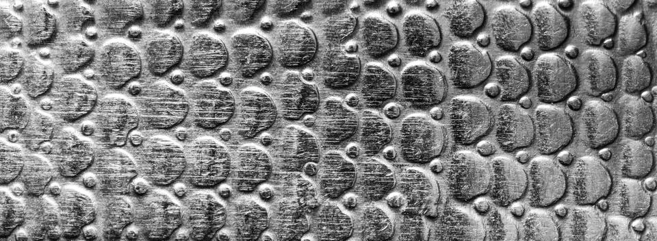 Scratched metal texture with round pattern. Abstract background of steel. B.. Stock Photos