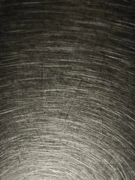 Scratches and circular swirl patterns on a worn stainless steel table top c.. Stock Photos