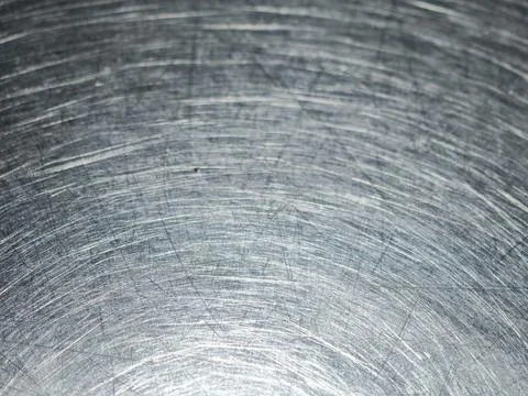 Scratches and circular swirl patterns on a worn stainless steel table top c.. Stock Photos