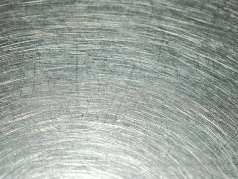 Scratches and circular swirl patterns on a worn stainless steel table top c.. Stock Photos