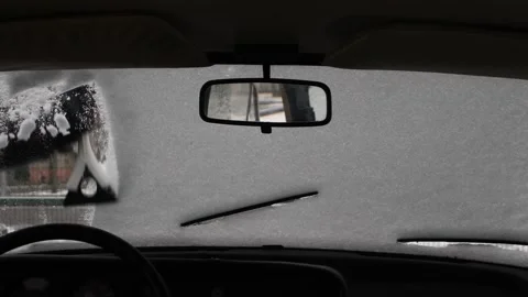Scratching ice and cleaning snow from a vintage car windshield Stock Footage 147172098