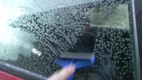 Scratching Ice from Frozen Car Window with Blue Ice Scraper Stock Footage 146574396