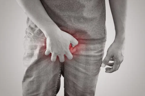 Scratching the penis Foto stock
