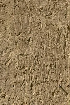 Scratchy stucco wall surface creates textured background plate Stock Photos
