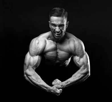 Scream of rage in the bodybuilder during training. Stock Photos