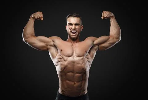 Scream of rage in the bodybuilder during training. Stock Photos