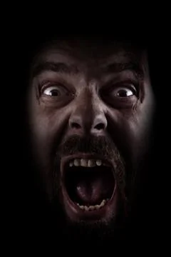 Scream of scared spooky man in dark Stock Photos